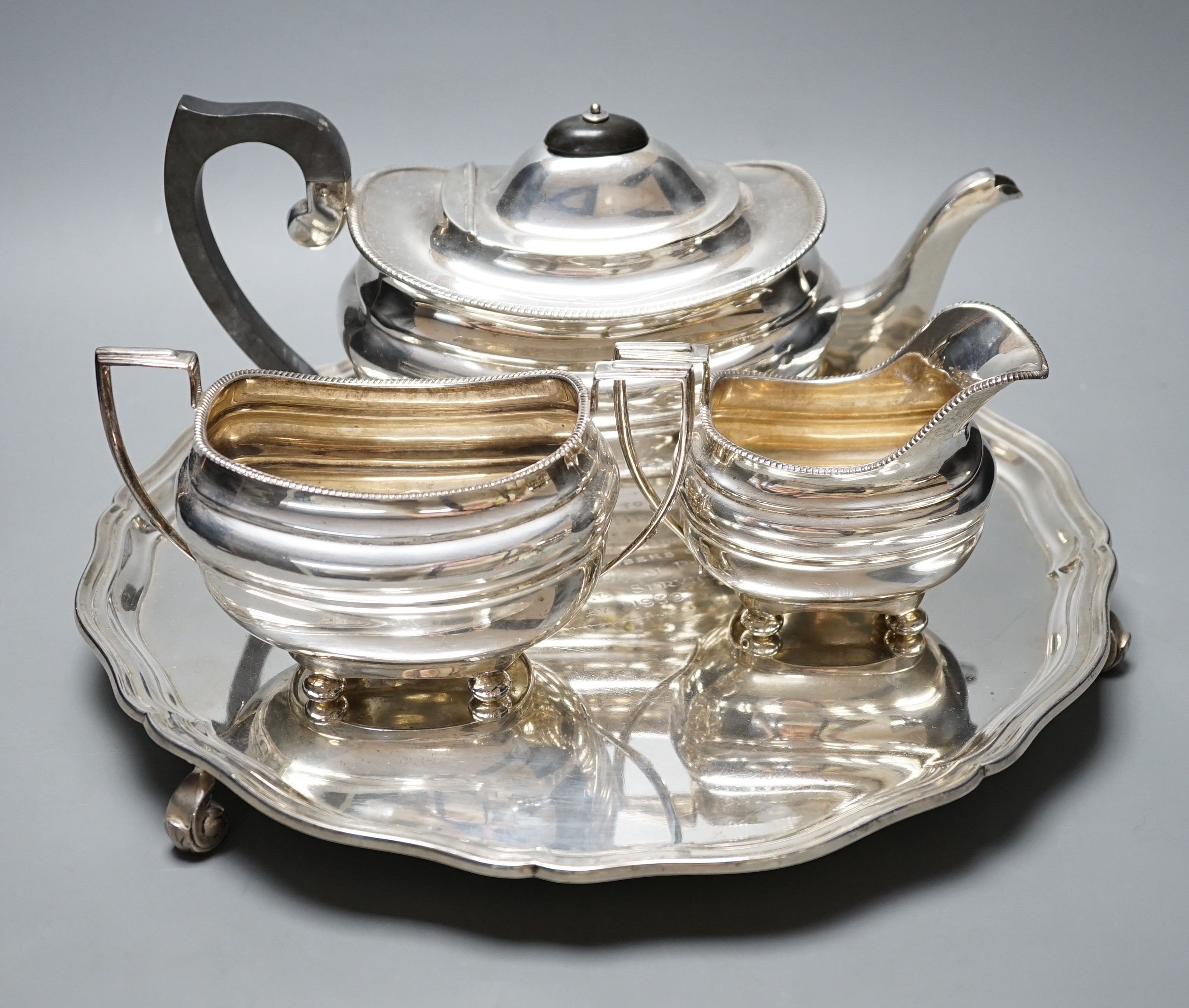 A George VI silver three piece tea set and circular tray, S. Blanckensee & Son Ltd, Chester, 1937/1938, the tray with engraved presentation inscription